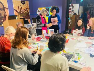 People taking part in a zine making workshop